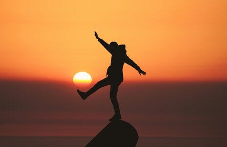 Photo by Aziz Acharki - person jumping at sunset